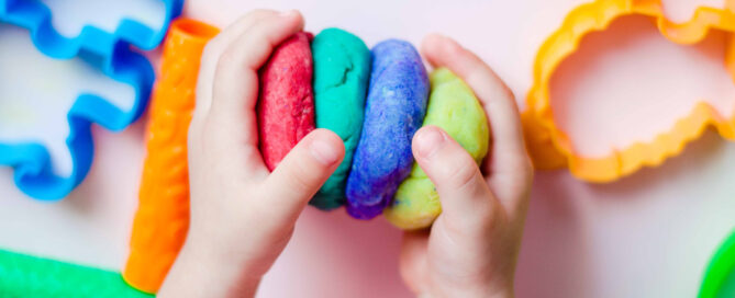 Child's hand holding playdough